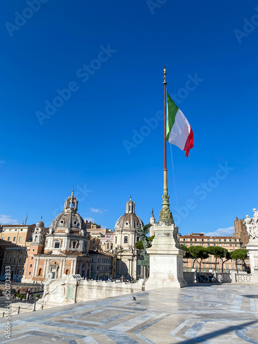 Close view on the Itlay flag fluttering on the flagpole in the Vittorio Emmanuelle II National Monument in Rome