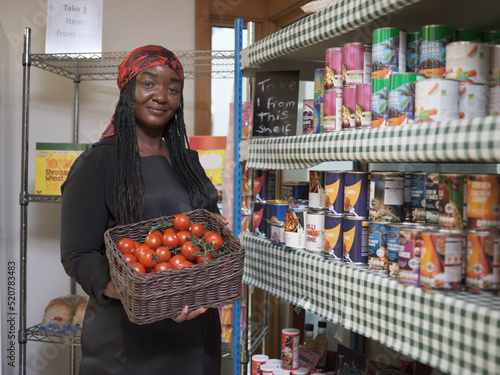 Portrait of female volunteer working in community food center