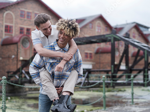 Man giving boyfriend piggyback ride