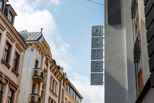 Hotel sign on the street. 5 separate letters.