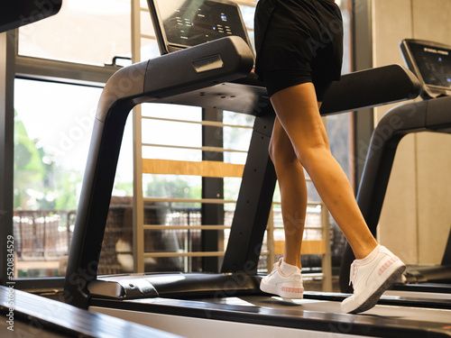 young woman running on treadmill