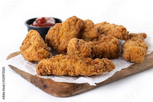 Crispy Kentucky fried chicken on cutting board isolated on white background