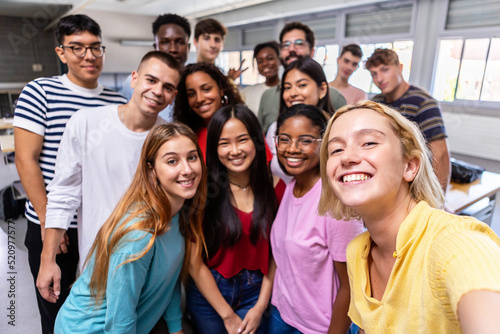 United multiracial big group of student friends taking selfie with teacher at college - Teenage high school people having fun together in classroom - Youth lifestyle, education and community concept