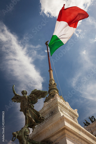 Italian flag fluttering over Vittorio Emmanuelle II National Monument in Rome