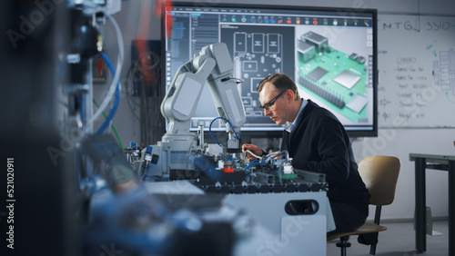 Electronics Engineer Works with Robot, Examining Circuits Using Screwdriver. Computer Science Research Laboratory with Specialists Working. High-Tech Science and Engineering Concept