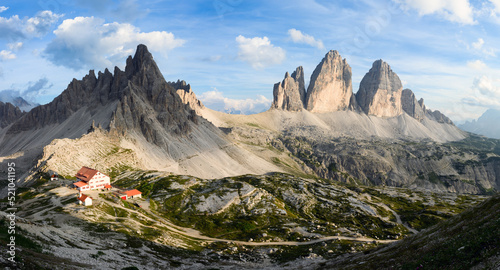 Stunning panoramic view of the Three Peaks of Lavaredo, (Tre cime di Lavaredo) Mount Paterno and a refuge during a beautiful sunny day