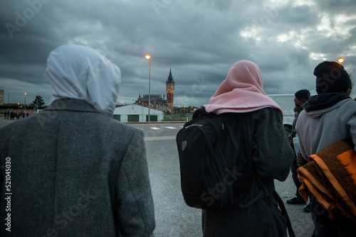 Refugee Crisis in France. October 25, 2014. Calais, France. A group of refugees walk in the center of the city. Calais is a major step for thousands of migrants who try to pass in secret in England.