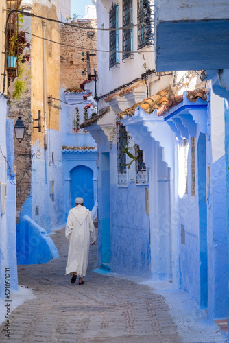 Muslim man walking down the street of Essaouira, Morocco