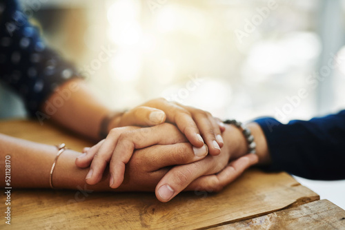 Holding hands, support and comfort of two people talking through a difficult problem. Closeup of friends showing care and love through a hard time, consoling each other and bonding