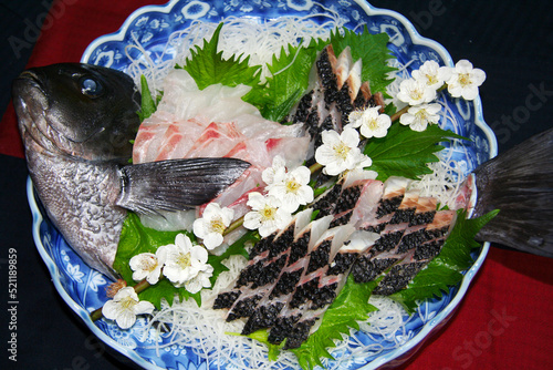 Saltwater fish “MEJINA”, cooked as a live style sashimi with plum flower branch decoration to enjoy the coming of the spring season cerebration.寒グレの姿造り、香りが旨い焼霜造りと併せて盛りつけに白梅の枝をあしらった一皿。