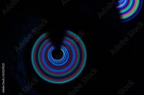 Time-lapse photograph of an uncompleted circle with multicolor light.