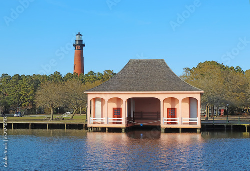 The Currituck Beach Lighthouse and pink boathouse near Corolla, North Carolina