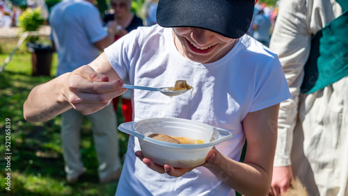 Volunteers distribute food to the poor outdoors, selective focus