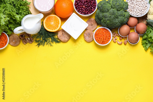 Food high in calcium. Flat lay composition with different products on yellow background, space for text