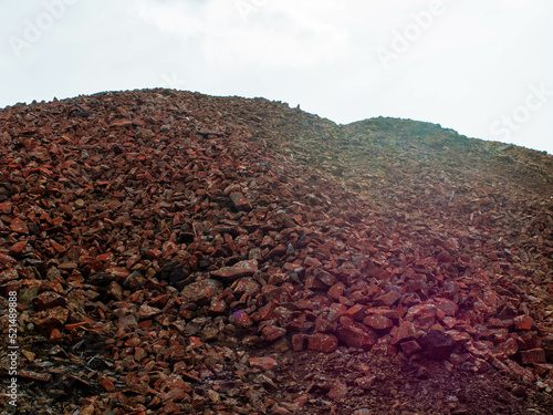 Enormous mountain of red copper mine slag stones and rocks from Falu Copper Mine World Heritage
