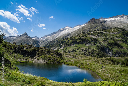 Spectacular, wonderful and evocative landscape of a lake in the Pyrenees surrounded by mountains and snow-capped peaks of Benasque. In HDR color.