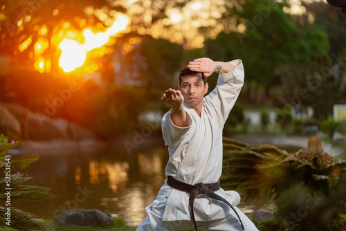 Karate black belt man performing kata outdoors