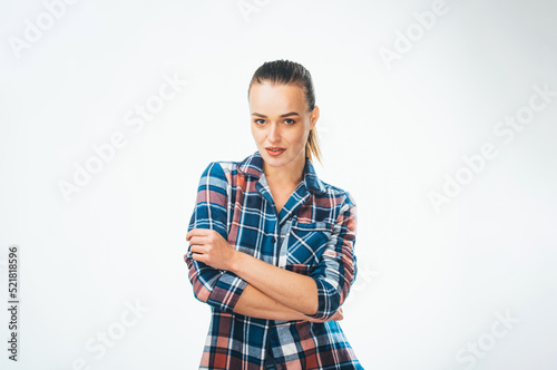 Beautiful pretty woman in lifestyle checkered shirt. Young female model posing on white background.
