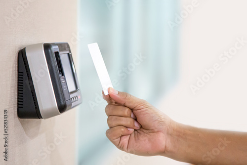 Proximity card reader door unlock, Hand security man using ID card on fingerprint scanning access control system for identity verification to open the door or for security safety or check attendance.