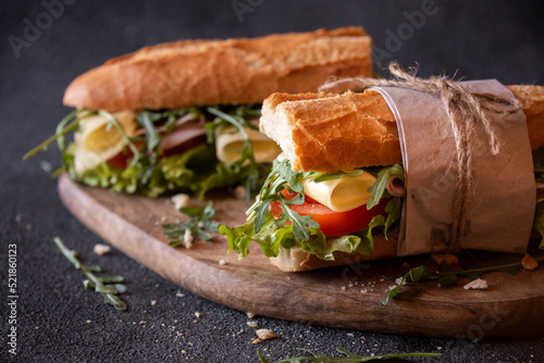 Baguette sandwich with cheese, ham, tomatoes and vegetables