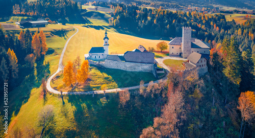 Panoramic autumn view from flying drone of Kapelle (Cappella di castel Lamberto) castel. Spectacular morning scene of Dolomite Alps, Italy, Europe. Traveling concept background.
