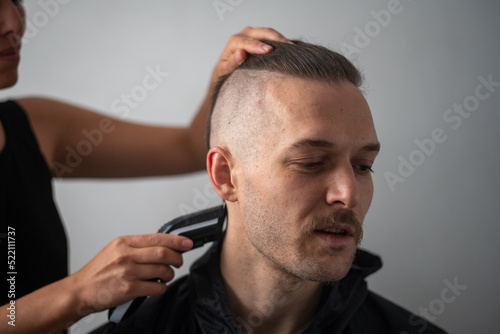 Young White Male with Beard get a Hair Cut by a Peruvian Woman