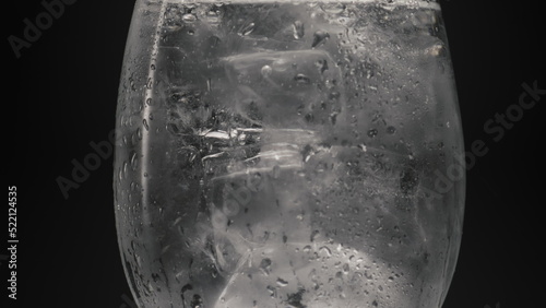 Ice cubes cold water glass closeup. Refreshing tonic concept