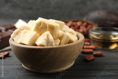 Organic cocoa butter on black wooden table, closeup