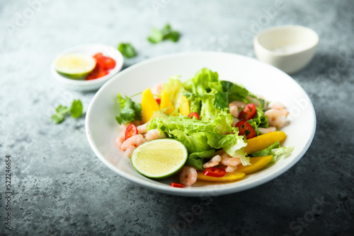 Fresh green salad with shrimps and mango