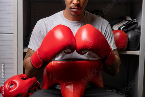 Mature man in boxing gloves, midsection