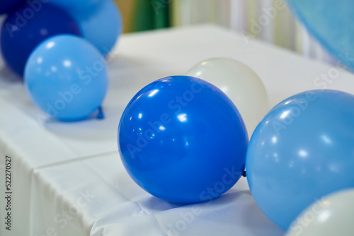 Balloons in blue colors on the holiday lying on the table