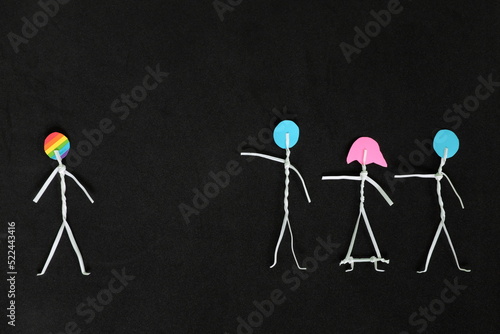 LGBT or LGBTQIA bullying, insult and harassment, discrimination and homophobia concept. Human stick figure in dark black background creative composition.