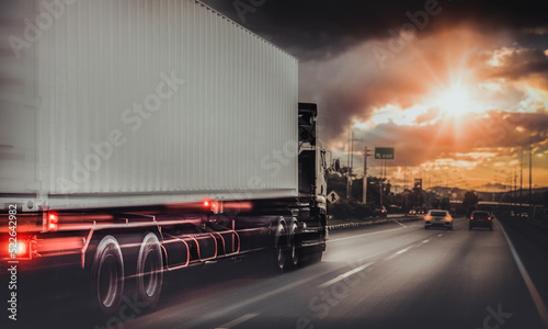Lorry Cargo Transport Delivery in motion, Motorway, Car truck driving on highway at sunset freight, with speed 