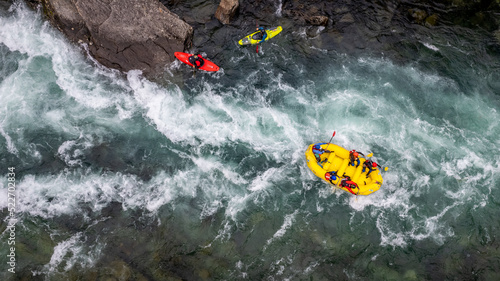 Group of friends spending time on the river enjoying kayaking and rafting together