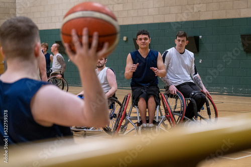 Men in wheelchairs playing basketball