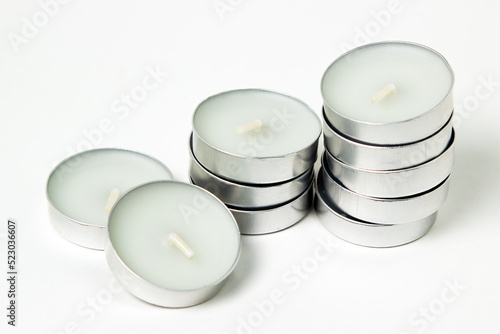 Tea candles on a white background. Set of tea lights.