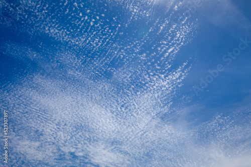 Bright and intense blue sky with white altocumulus clouds perfect for backgrounds and graphic resources