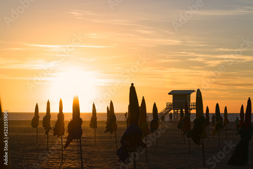 Sunset behind the parasols of Deauville in Normandy