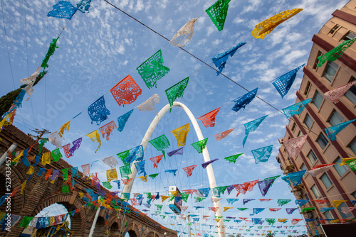 Daytime papel picado framed view of the iconic landmark arch of downtown Tijuana, Baja California, Mexico.