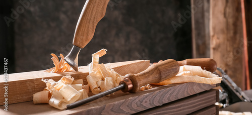 Carpenter's chisels on wooden box in workshop