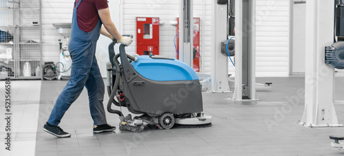 Close-up sweeper machine cleaning. Concept clean airport, garage, clinic from debris