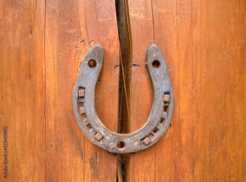 Horseshoe on a wooden crack. The concept of good luck and safety. Protect from destruction, failures and misfortunes. Superstitions and beliefs. Problem solution. Strengthening and security. Insurance