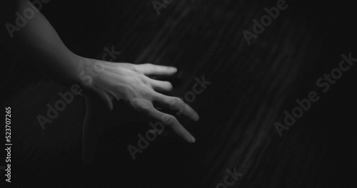 Image of hand walking in dark space