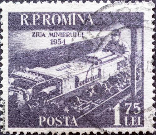 Romania - Circa 1954: A Postage Stamp from Romania, Showing A Miner with Coal Combine. Around 1954
