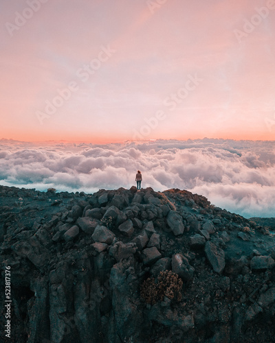 top of the halekakala volcano in Maui, Hawaii during sunset with a sea of clouds
