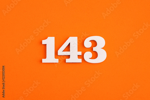 White wooden number 143 on eva rubber orange background