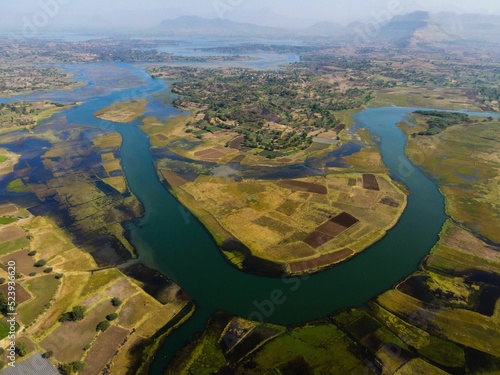 Aerial shot of the Zambezi river surrounded by cultivated land and forests