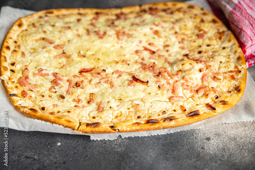 Flammkuchen savory pie bacon, onion, sour cream pastrie meal food snack on the table copy space food background