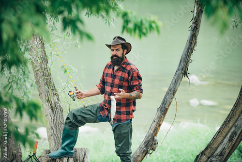 Fishing hobby and summer weekend. Portrait of bearded men fisher with fishing rod and net. Angler.