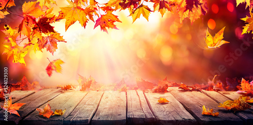 Autumn - Wooden Table With Orange Leaves At Sunset In Defocused Abstract Background
